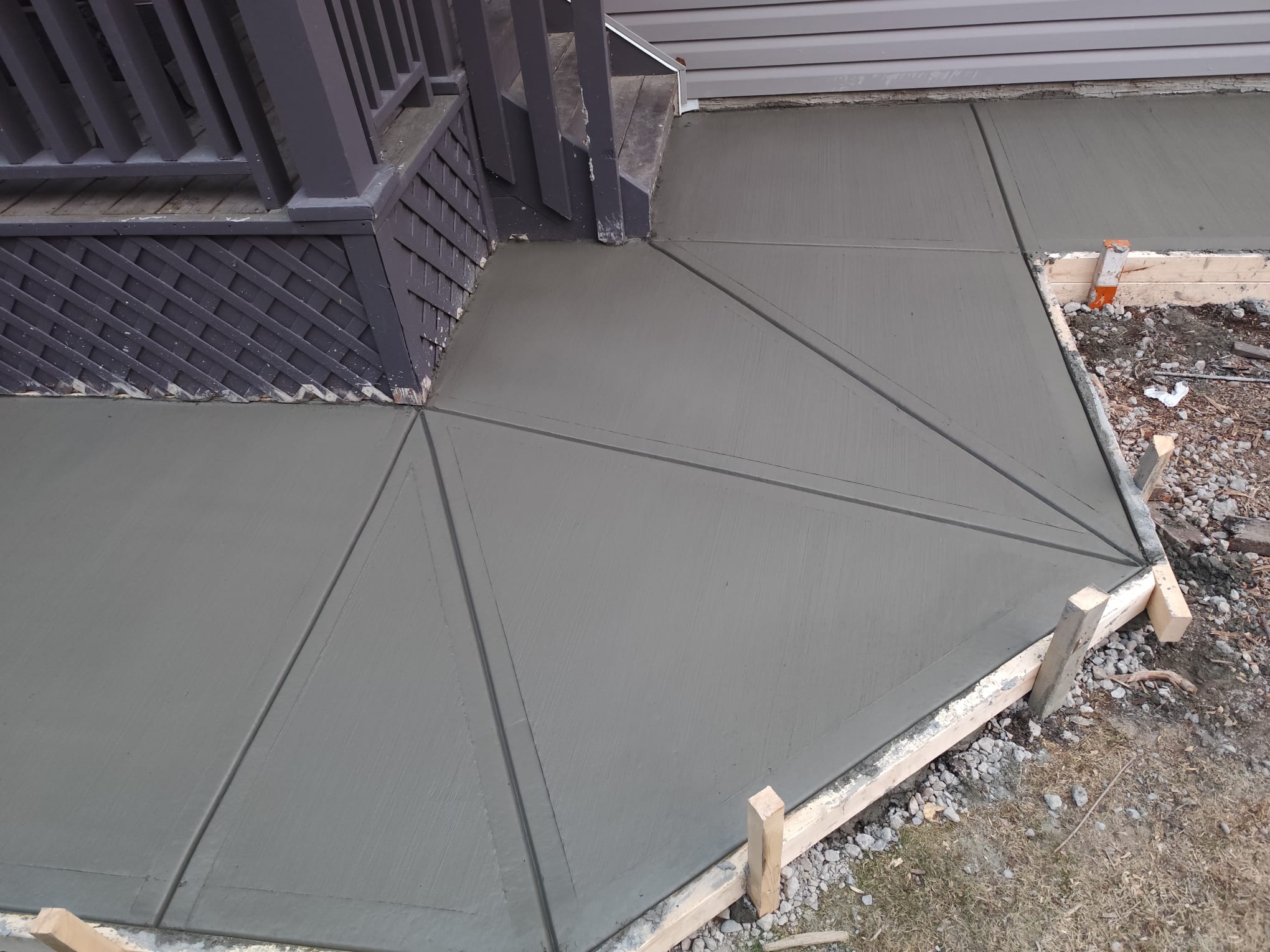 Custom broom concrete patio with decorative angled joints Calgary
