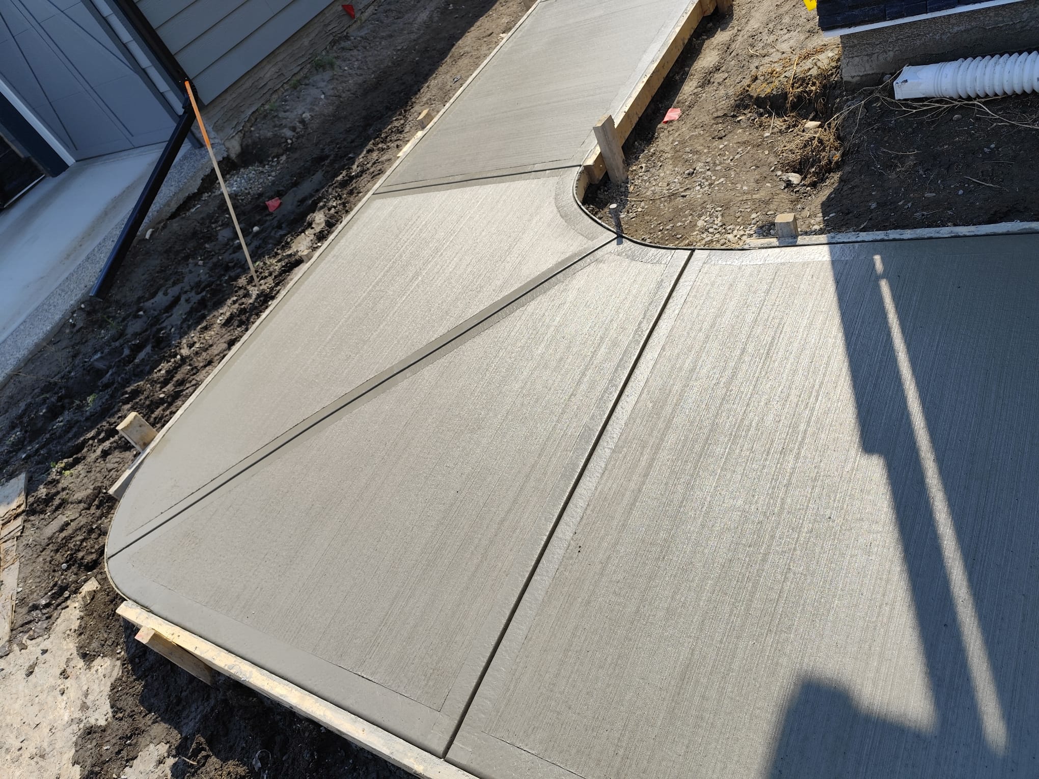 Curved broom finish sidewalk corner Calgary