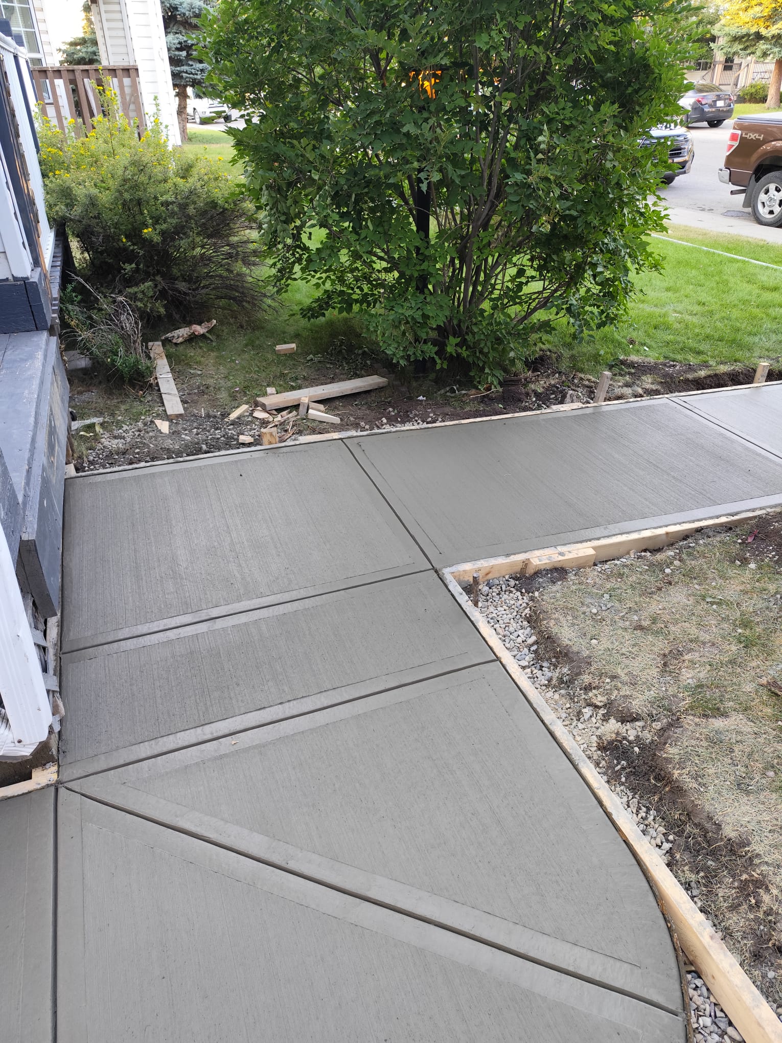 Freshly poured broom finish walkway with picture frame border Calgary
