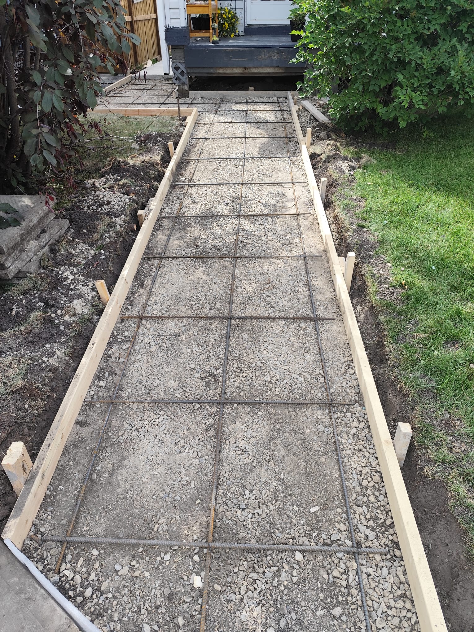 Long residential walkway formwork and rebar prep Calgary