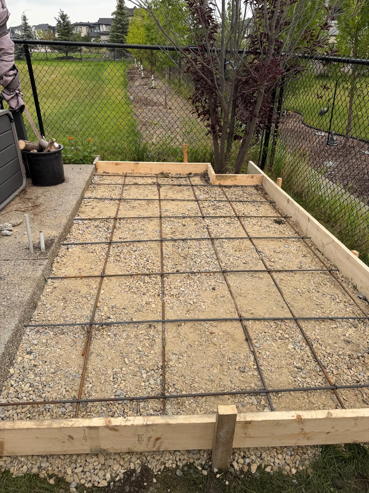 Gravel subgrade and tied rebar grid patio prep Calgary