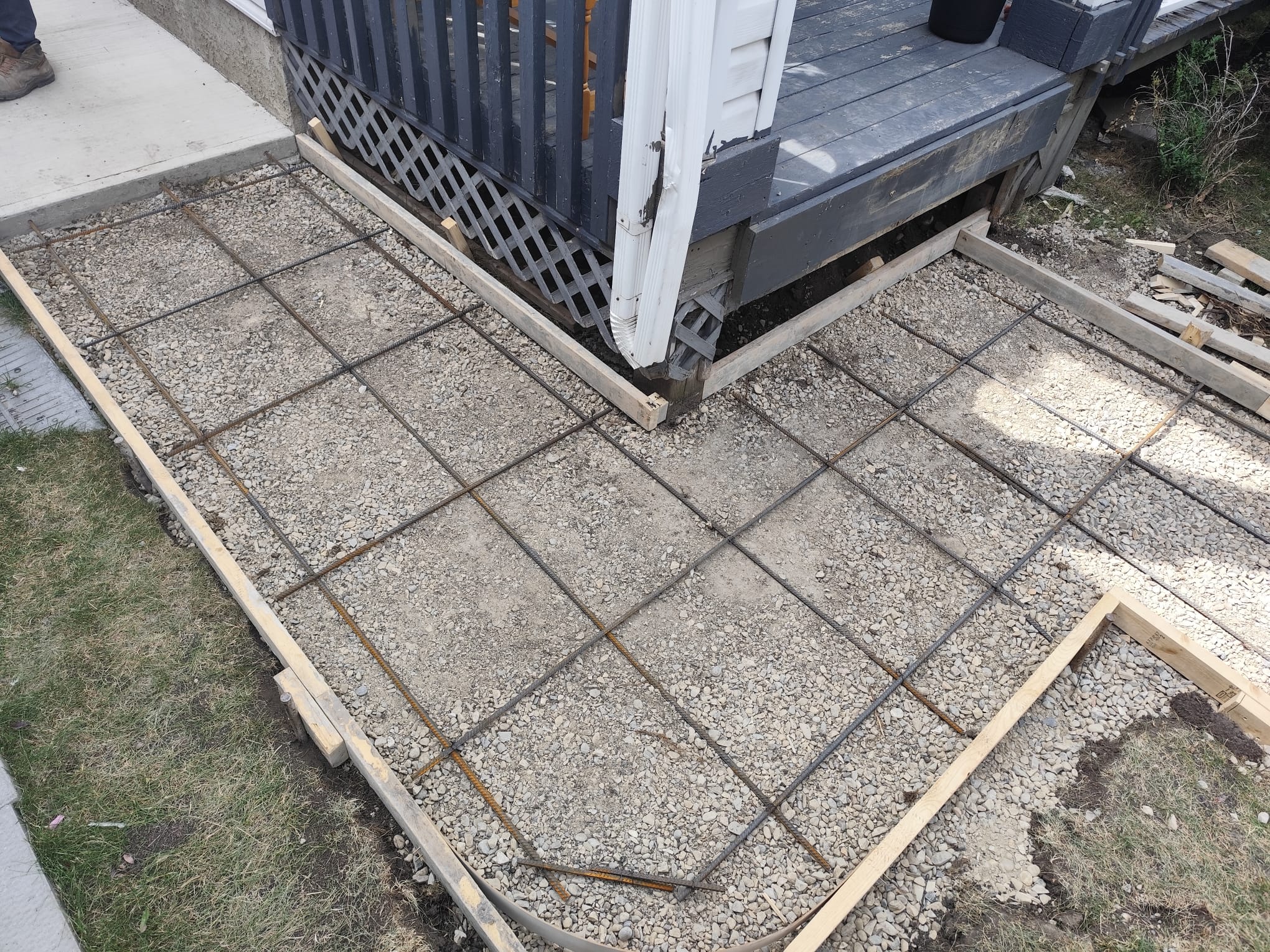Side yard walkway rebar tying over gravel base Calgary